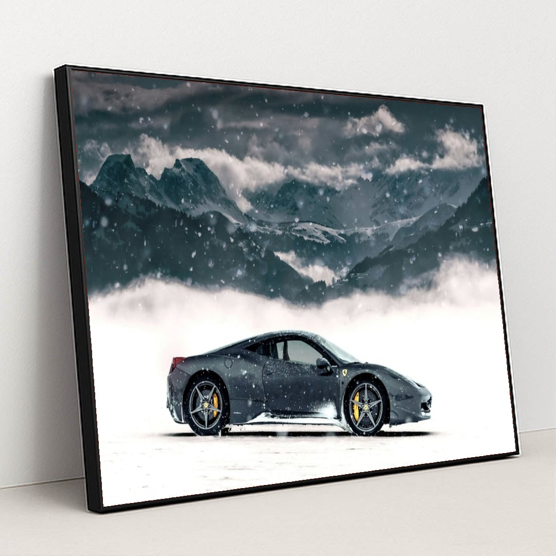 This photo shows a black Ferrari coupe parked in snow with snowy mountains in the background, in a black frame.