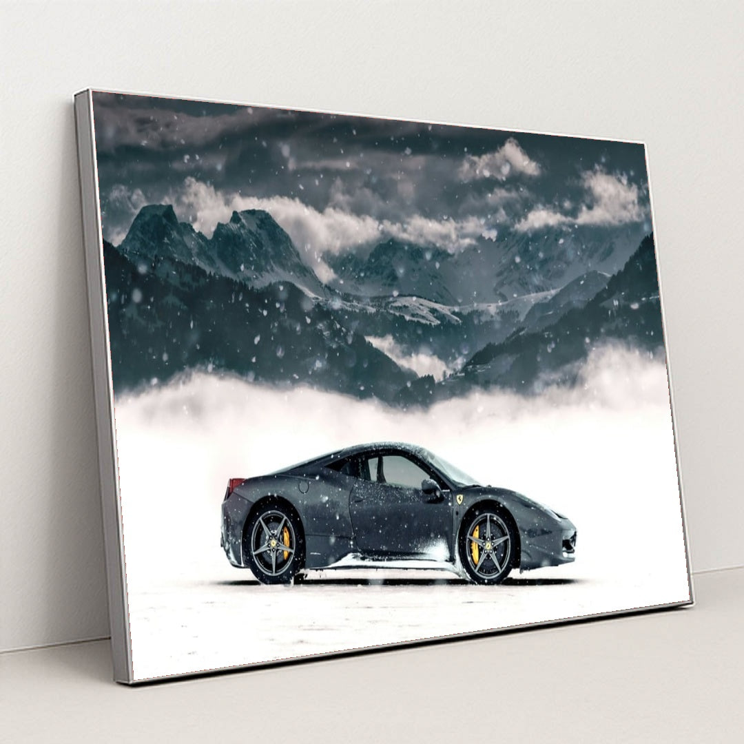 This photo shows a black Ferrari coupe parked in snow with snowy mountains in the background, in a silver frame.