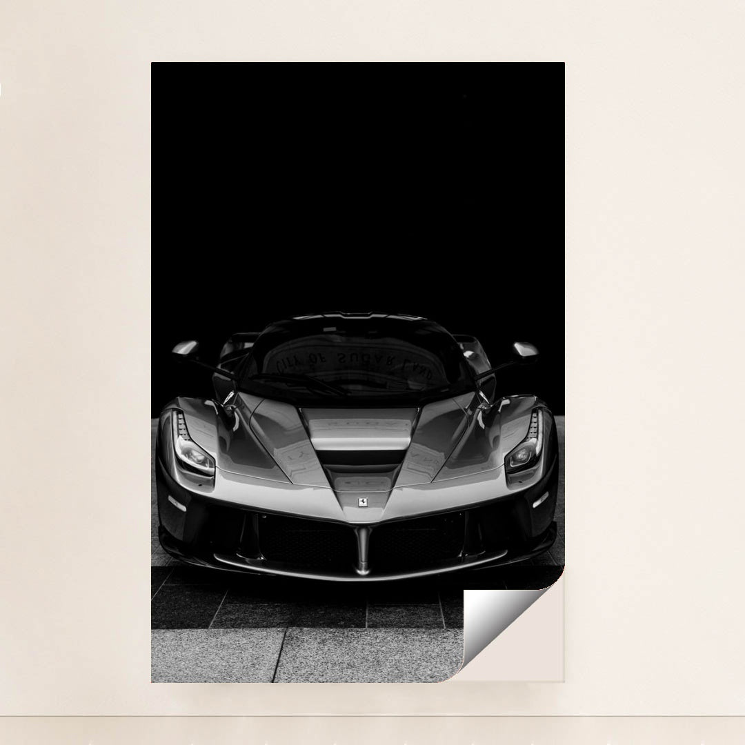 This photo shows a black and white front view of a Ferrari LaFerrari against a dark background, unframed style.