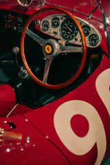 Close-up of Classic Ferrari Racing Dash featuring polished wood steering wheel and vintage gauges, ideal car wall art.