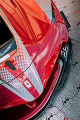 Close-up of Ferrari Frontline car wall art showcasing glossy red paint and bold silver stripe.