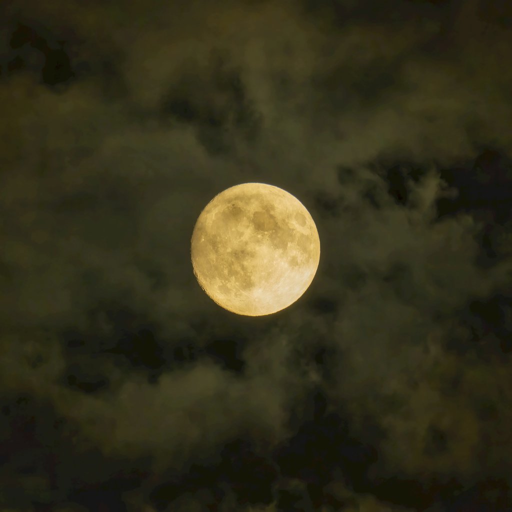 Tom Fisk - A striking full moon captured in a cloudy night sky, creating a dramatic and atmospheric scene.