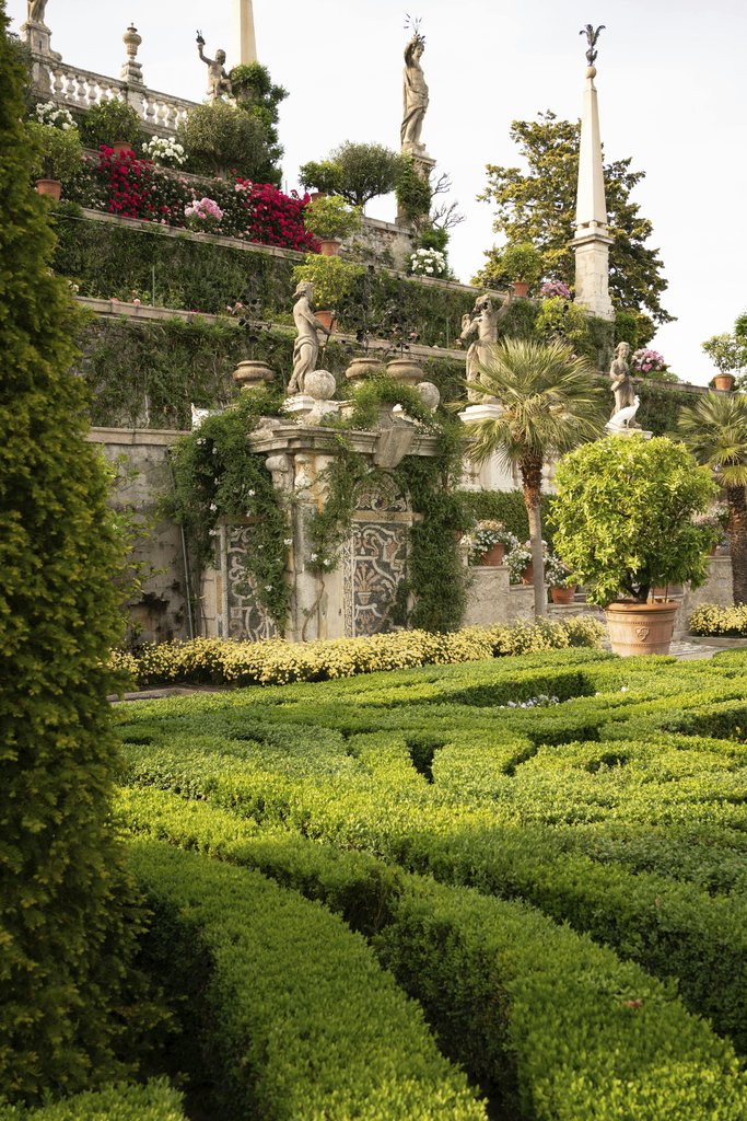 Mikita Yo - Italian garden in Stresa, Italy featuring lush greenery and classical sculptures.