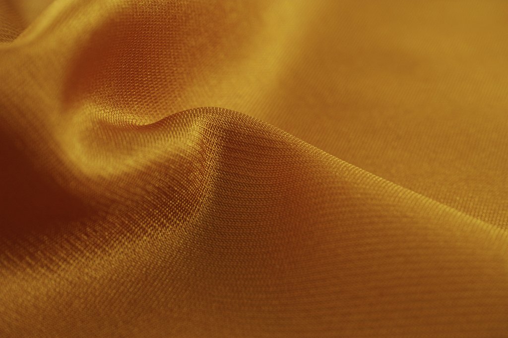 Engin Akyurt - Close-up of a smooth, golden silk fabric showcasing its luxurious texture and shine.