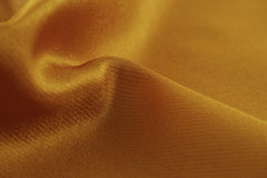 Engin Akyurt - Close-up of a smooth, golden silk fabric showcasing its luxurious texture and shine.