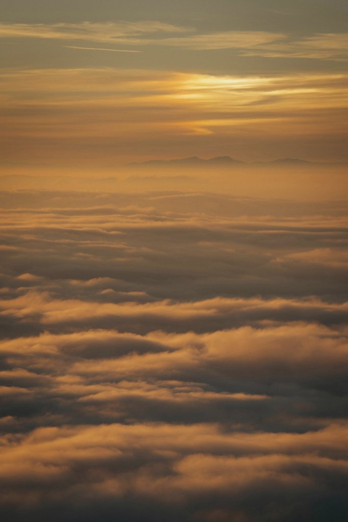 Sergio Zhukov - Breathtaking view of a sunset above the clouds, capturing the serene beauty of nature.