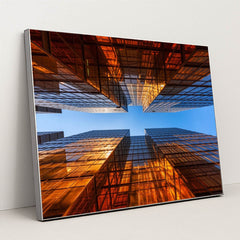 Golden Glass Towers Reflecting Sunset Against Clear Blue Sky by Anonymous - Silver Frame Stretchiez
