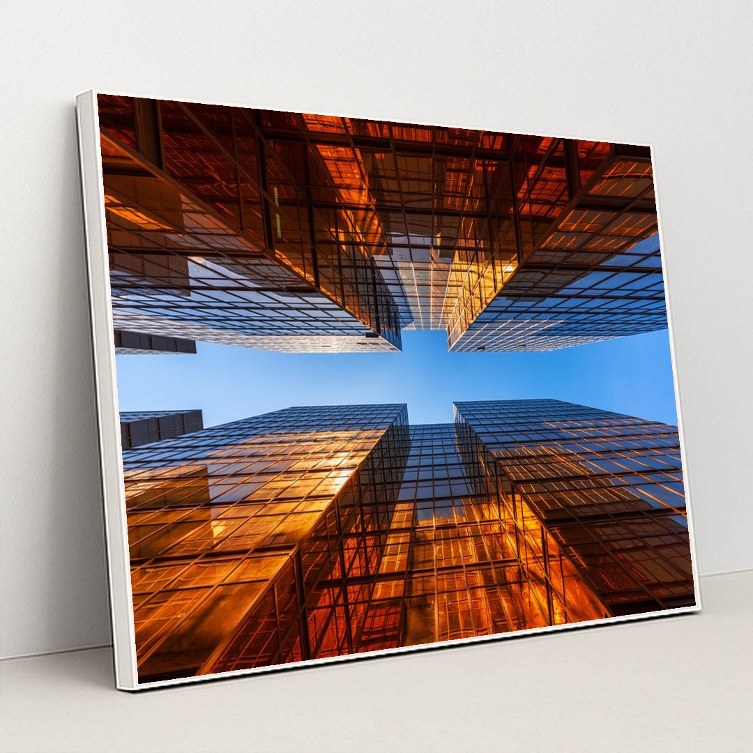 Golden Glass Towers Reflecting Sunset Against Clear Blue Sky by Anonymous - White Frame Stretchiez