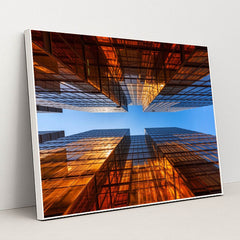Golden Glass Towers Reflecting Sunset Against Clear Blue Sky by Anonymous - White Frame Stretchiez