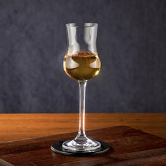 Marcelo Verfe - A single Glencairn glass filled with a golden spirit on a wooden surface.