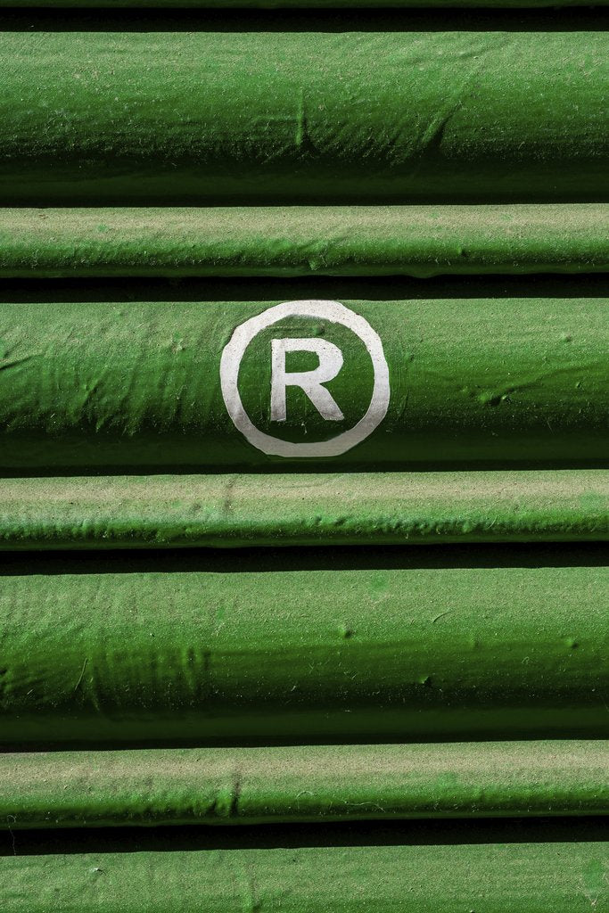 Victor  Moragriega - Close-up of green shutter with registered trademark symbol in white.