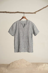 dayong tien - A grey t-shirt hangs on a branch against a textured background, capturing minimalist fashion.