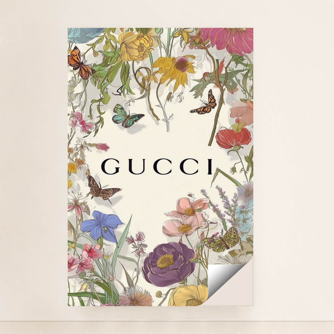 This artwork shows a floral Gucci design with colorful wildflowers, butterflies, and the Gucci logo on a pale background, minimalist unframed style.