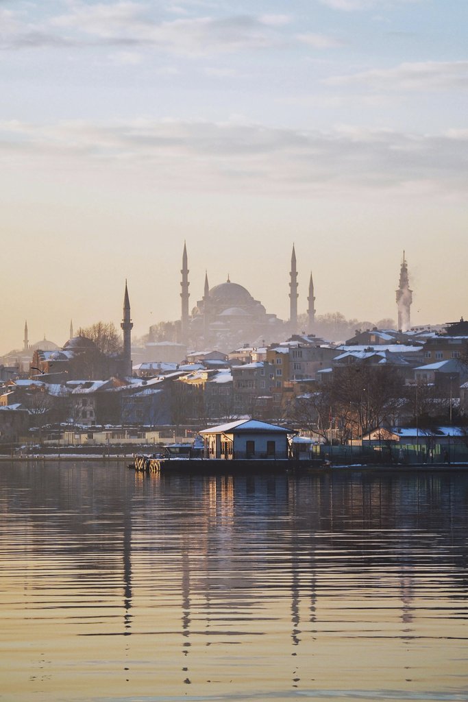 Mustafa Eker - A serene winter scene showcasing Istanbul's iconic skyline and architectural landmarks at sunrise.
