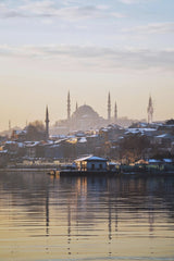 Mustafa Eker - A serene winter scene showcasing Istanbul's iconic skyline and architectural landmarks at sunrise.