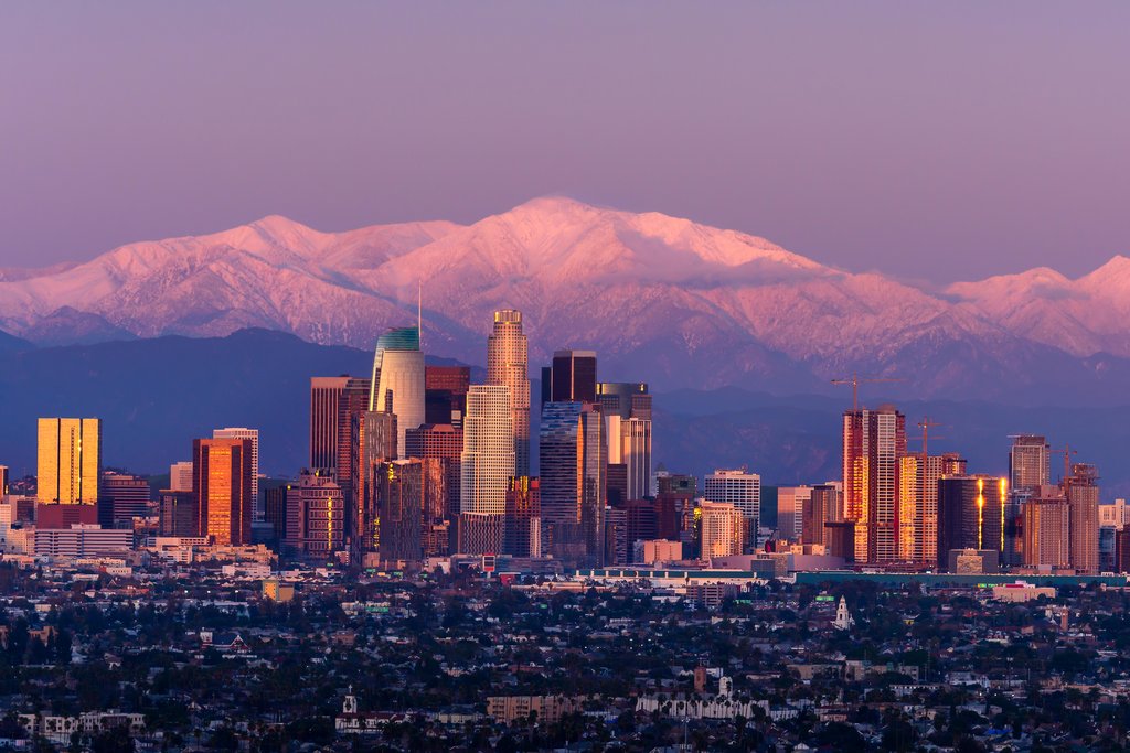 Stock Photos - Downtown Los Angeles skyline with snow capped mountains behind at twilight