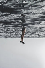 anouar olh - A surreal image of legs appearing to walk on the ocean surface, creating a dreamlike effect.
