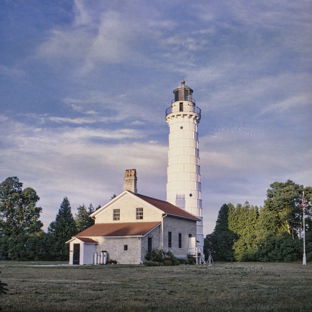 Tom Fisk - Beautiful view of a historic lighthouse in Two Harbors, Minnesota, surrounded by trees.