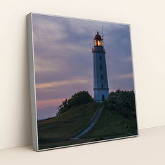 Illuminated Coastal Lighthouse on Hill During Evening Twilight by Karl Knips - Silver Frame Stretchiez