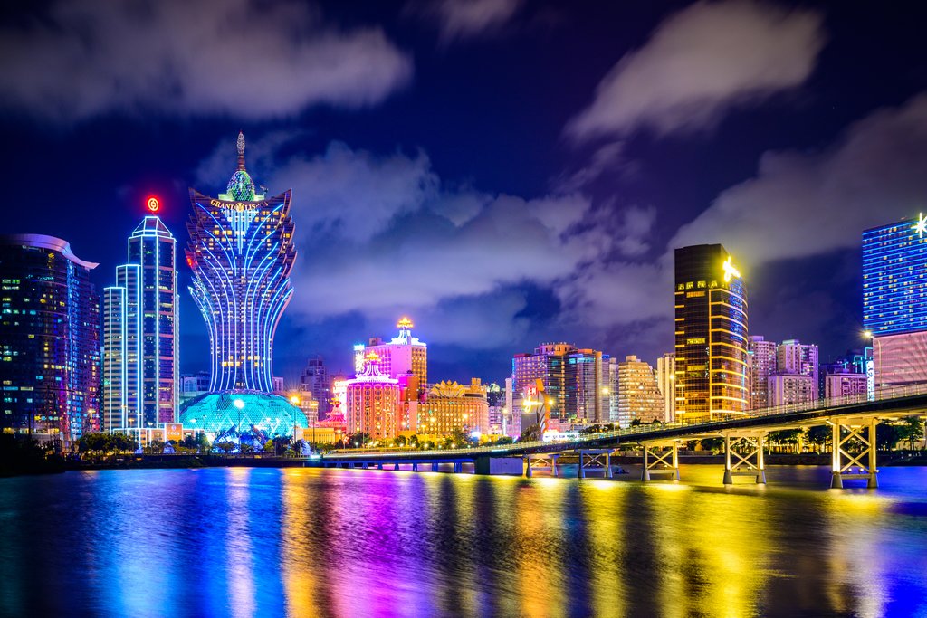 Vibrant Macau Cityscape Illuminated at Night by Anonymous