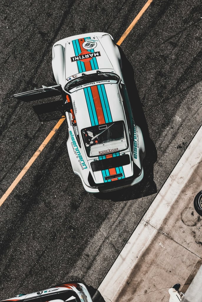 Porsche 911 in Tri-Tone Flair: A vibrant car wall art piece showcasing a white sports car with teal and red stripes.