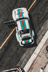 Porsche 911 in Tri-Tone Flair: A vibrant car wall art piece showcasing a white sports car with teal and red stripes.