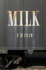 James Mirakian - Close-up of an antique train car featuring milk branding from 1920.