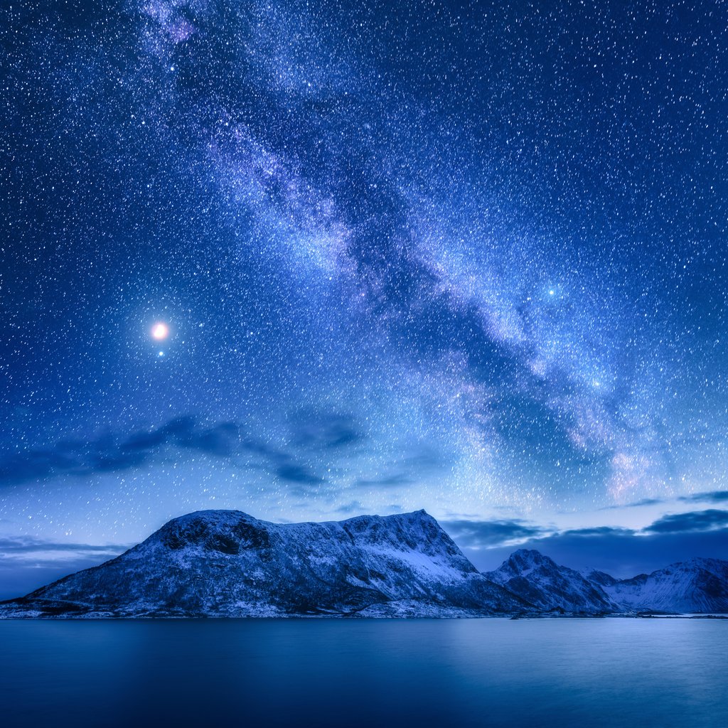 Stock Photos - Bright Milky Way over snow covered mountains and sea at night in winter in Norway