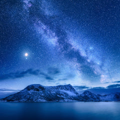 Stock Photos - Bright Milky Way over snow covered mountains and sea at night in winter in Norway