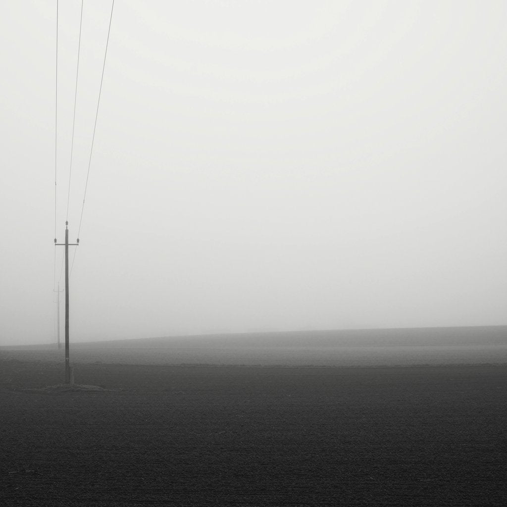 Simon Berger - A minimalist foggy landscape with power lines in Pinsdorf, Oberösterreich.