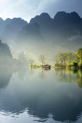 Quang Nguyen Vinh - Scenic view of a foggy lake surrounded by lush mountains in Tuyên Quang, Vietnam.