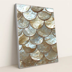 This artwork shows scalloped gold and pearl tiles in an overlapping scale pattern, in a silver frame.