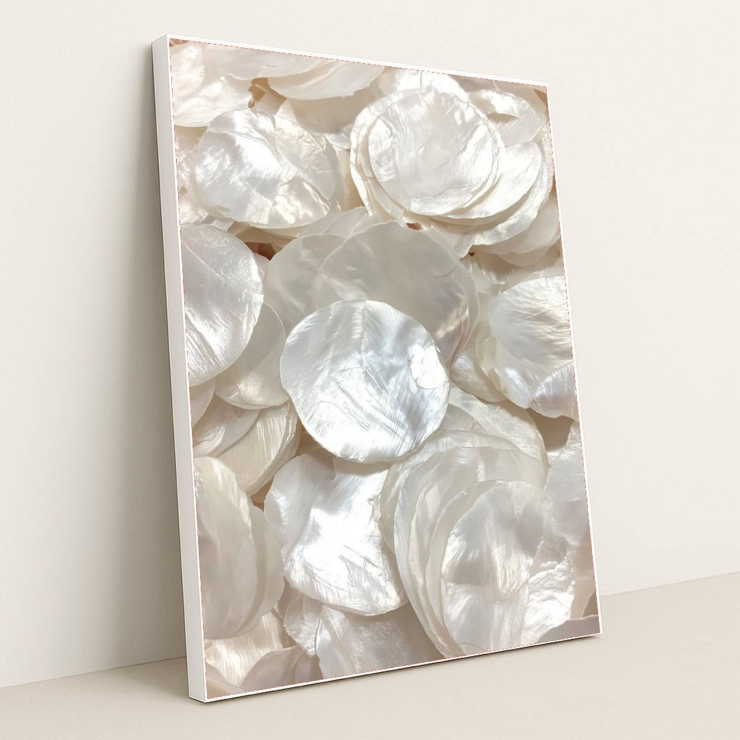 This artwork shows glossy, layered white capiz shells in soft light, in a white frame.