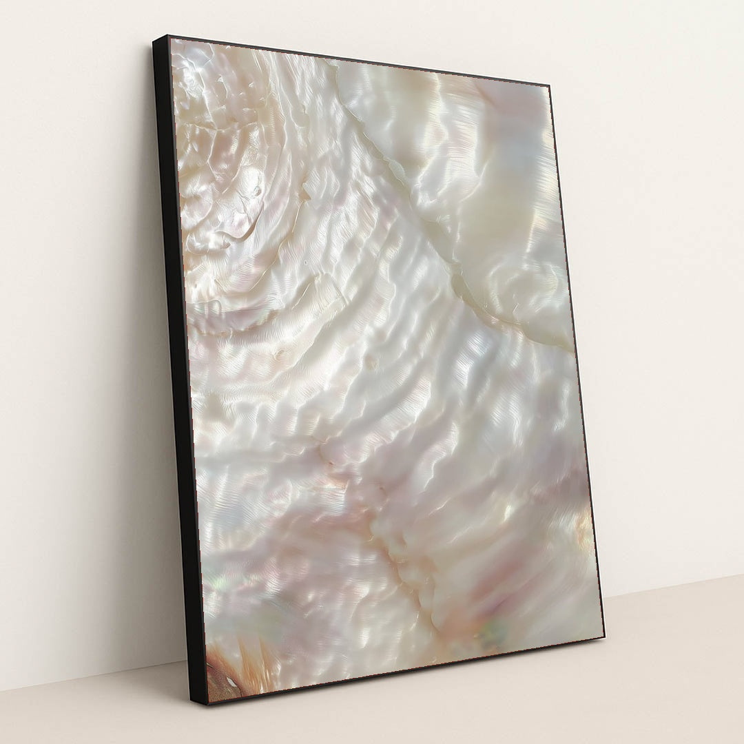 This artwork shows a close-up of iridescent mother-of-pearl shell with swirling light reflections, in a black frame.