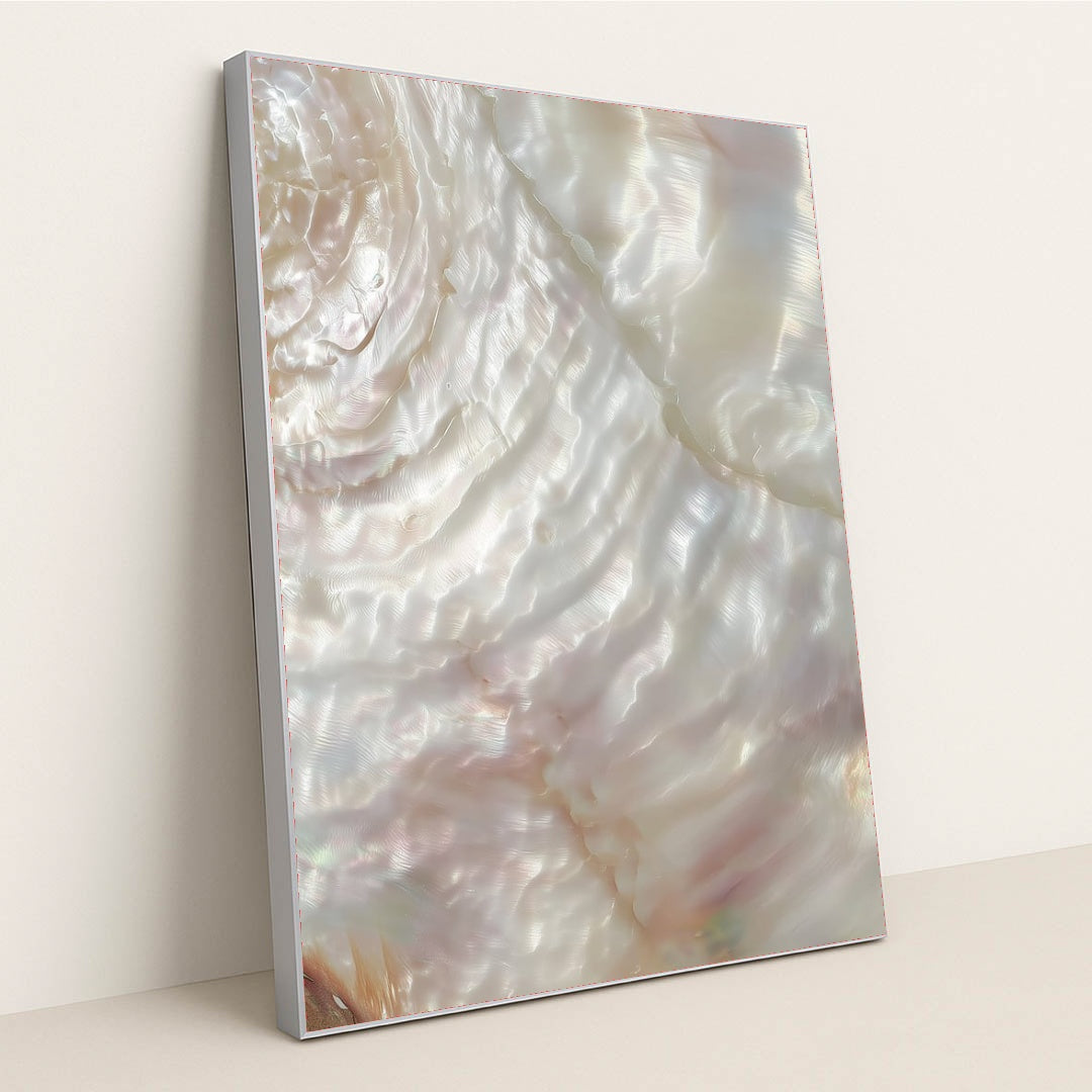 This artwork shows a close-up of iridescent mother-of-pearl shell with swirling light reflections, in a silver frame.