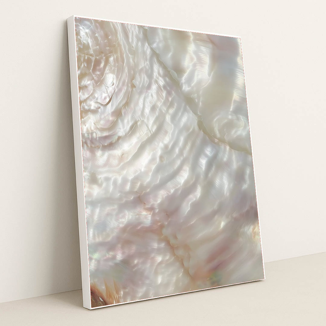 This artwork shows a close-up of iridescent mother-of-pearl shell with swirling light reflections, in a white frame.