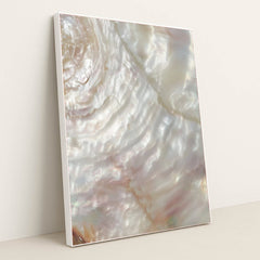 This artwork shows a close-up of iridescent mother-of-pearl shell with swirling light reflections, in a white frame.