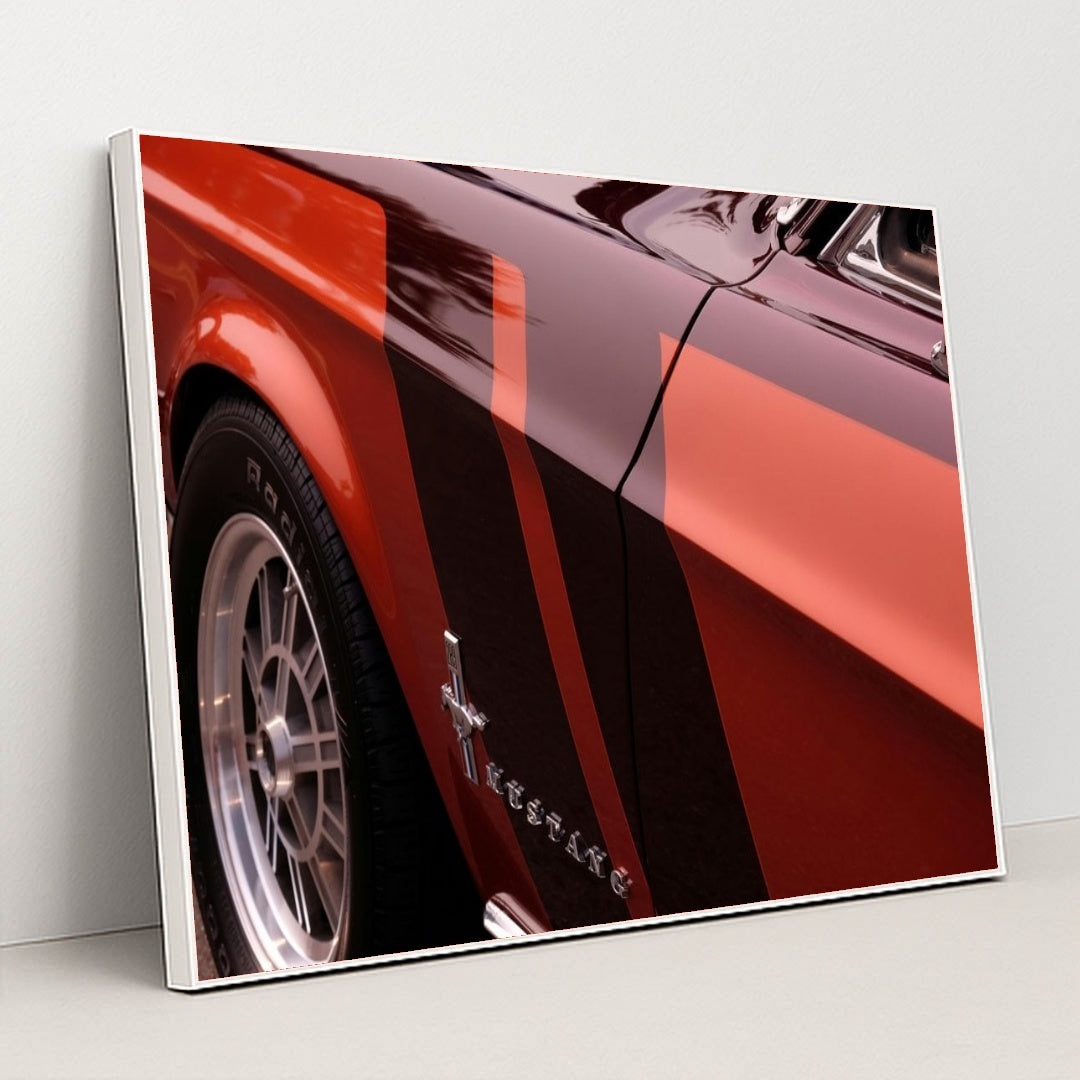 This artwork features a close-up of a classic red Ford Mustang with black and red racing stripes, in a white frame.