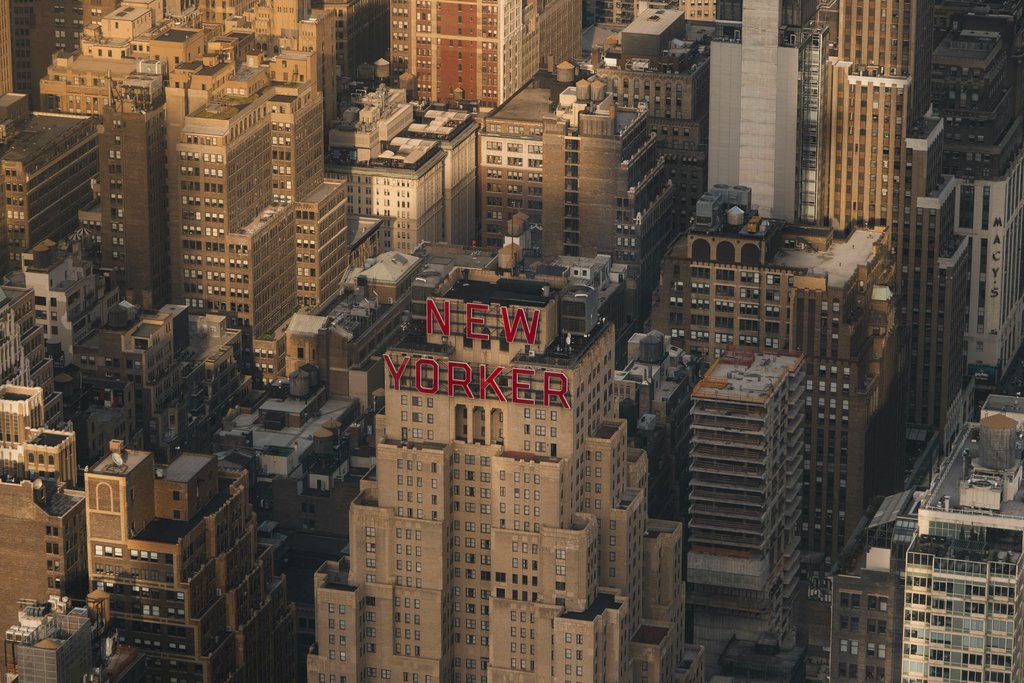 Ekam Juneja - Aerial view of the New Yorker Hotel amidst Manhattan's vibrant skyline.