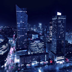 Adam Borkowski - Experience the dazzling night skyline of Warsaw with illuminated skyscrapers and vibrant city lights.