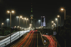 Optical Chemist - Vibrant light trails and illuminated skyline of Kuwait City at night, highlighting urban life.