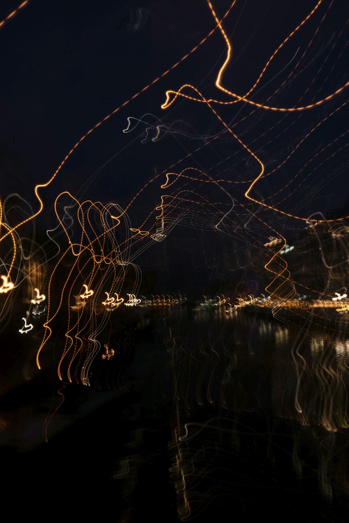 Katia Miasoed - Captivating abstract long exposure of light trails in a dark cityscape at night.