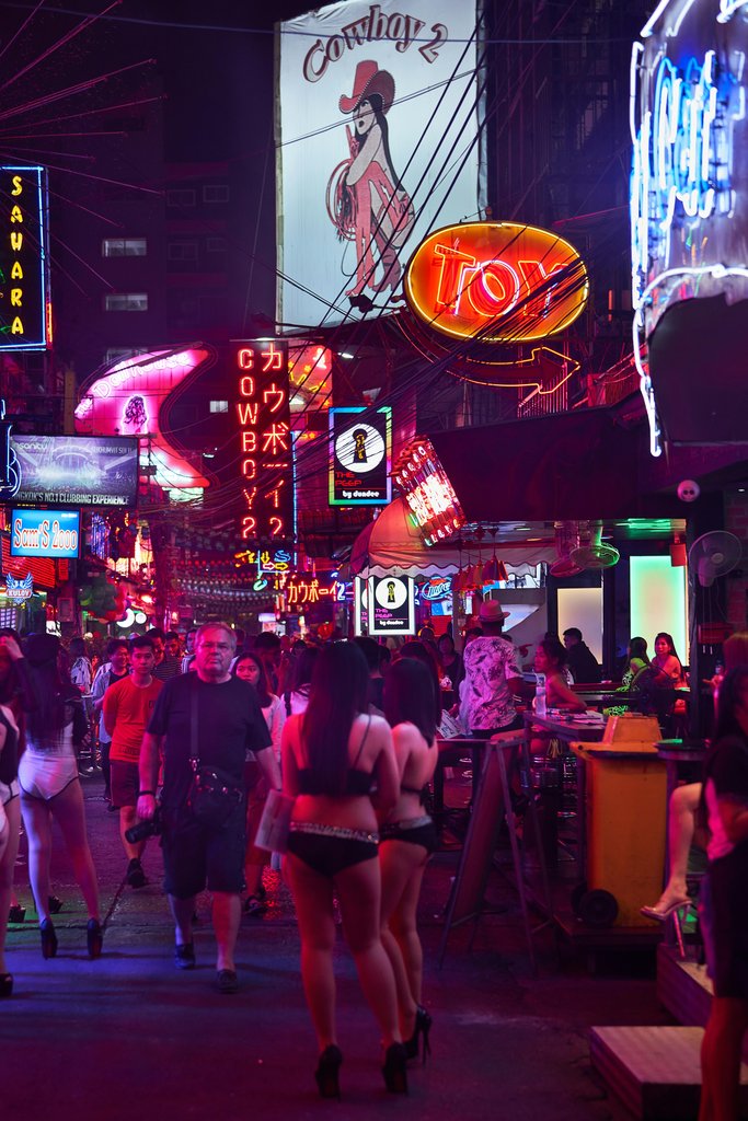 Norbert Braun - A group of people walking on a city street at night photo