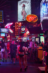 Norbert Braun - A group of people walking on a city street at night photo
