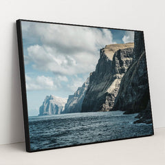 Majestic Ocean Cliffs Under Cloudy Sky by Raul Ling - Black Frame Stretchiez