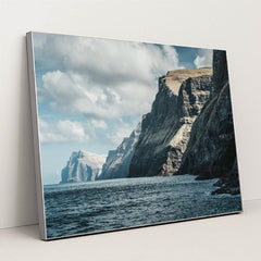 Majestic Ocean Cliffs Under Cloudy Sky by Raul Ling - Silver Frame Stretchiez