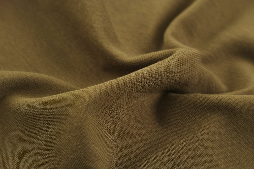 Engin Akyurt - Detailed close-up view of brown fabric with visible folds, creases, and texture.