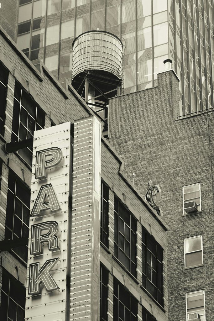 _ Whittington - Industrial charm in a New York cityscape featuring a vintage water tower and retro signage.