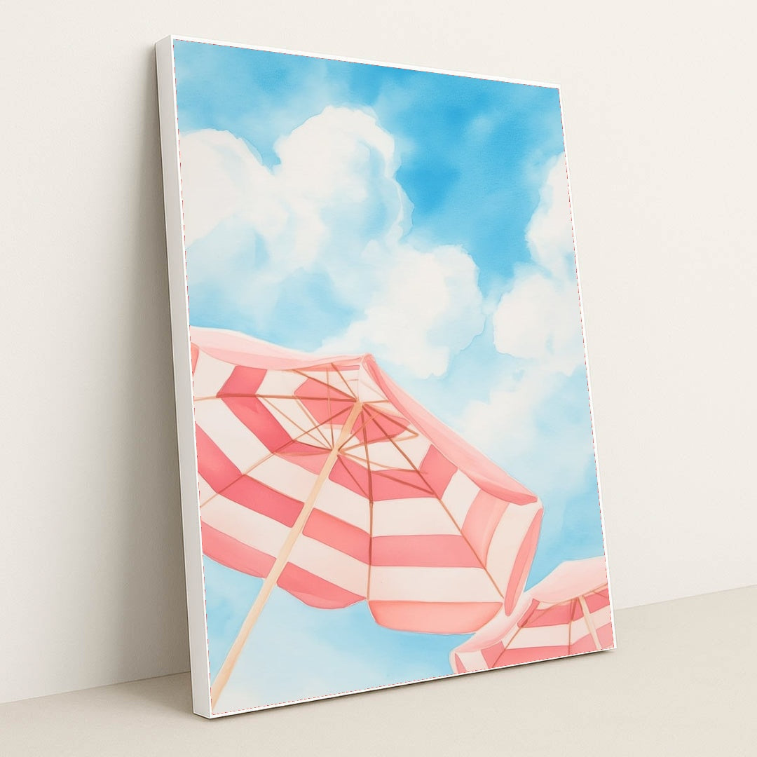 This artwork features pink and white striped beach umbrellas against a blue sky with clouds, in a white frame.
