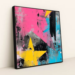 This artwork shows an abstract artwork with large yellow stars, pink and blue brushstrokes, and black and white textures, in a black frame.